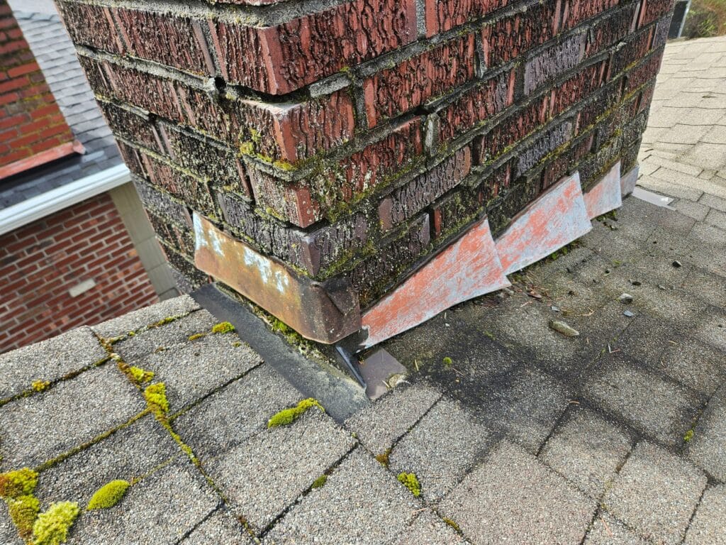 Chimney leak repair in Minnesota — professional evaluation of water entry at a masonry chimney showing crown, flashing and brick moisture sources
