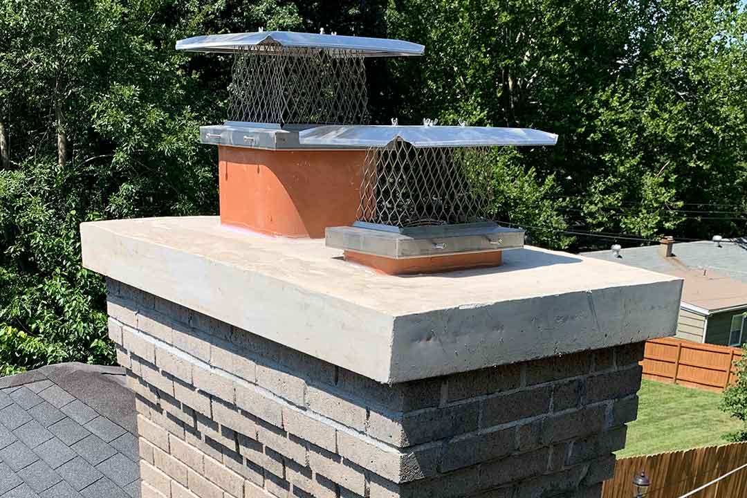 Chimney crown repair in Minnesota showing a sealed and restored masonry crown protecting the chimney top