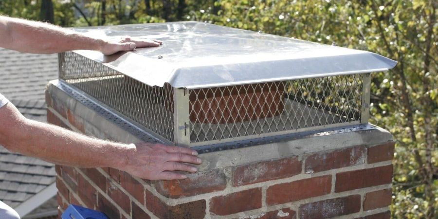 Chimney cap replacement in Minnesota with a properly fitted stainless steel cap on a masonry chimney